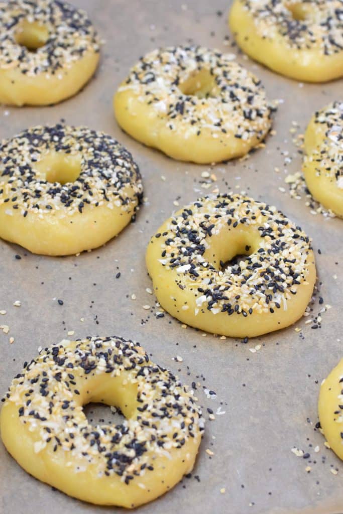 Pre baked keto bagels on a baking pan.
