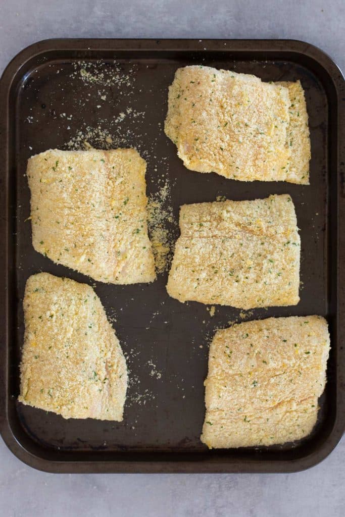 Keto breaded and crumbed fish on a tray ready to cook.