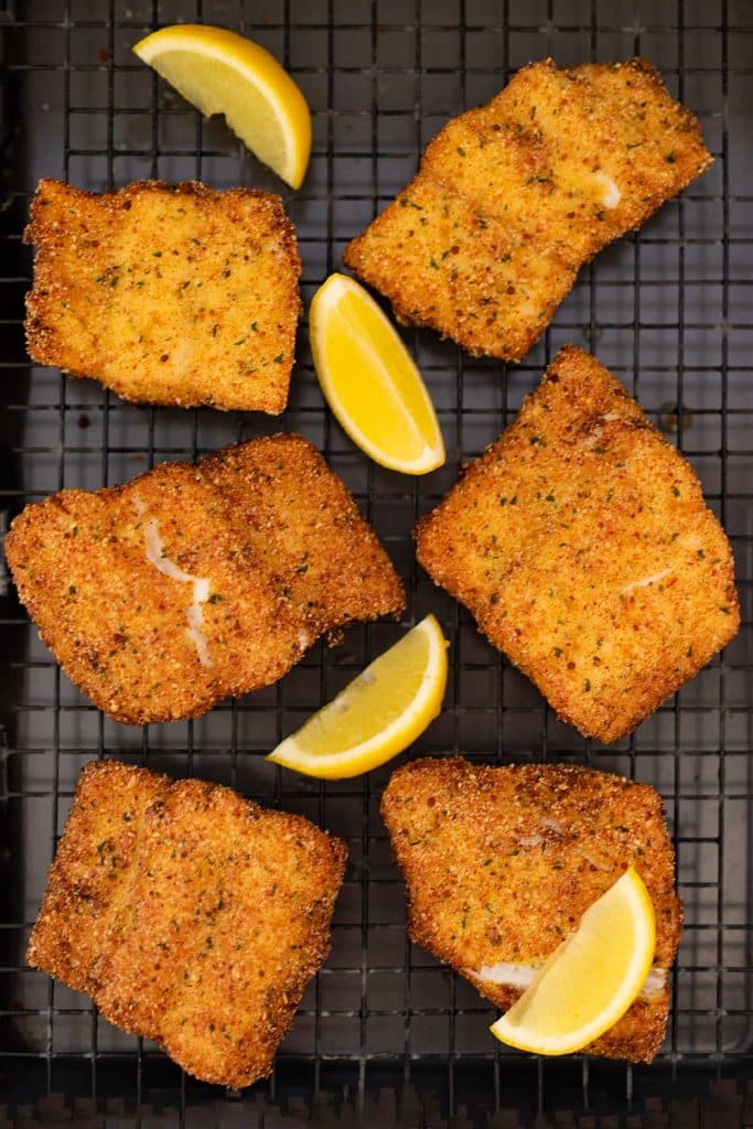 Keto breaded fried fish on a cooling rack with text saying, keto breaded fish."