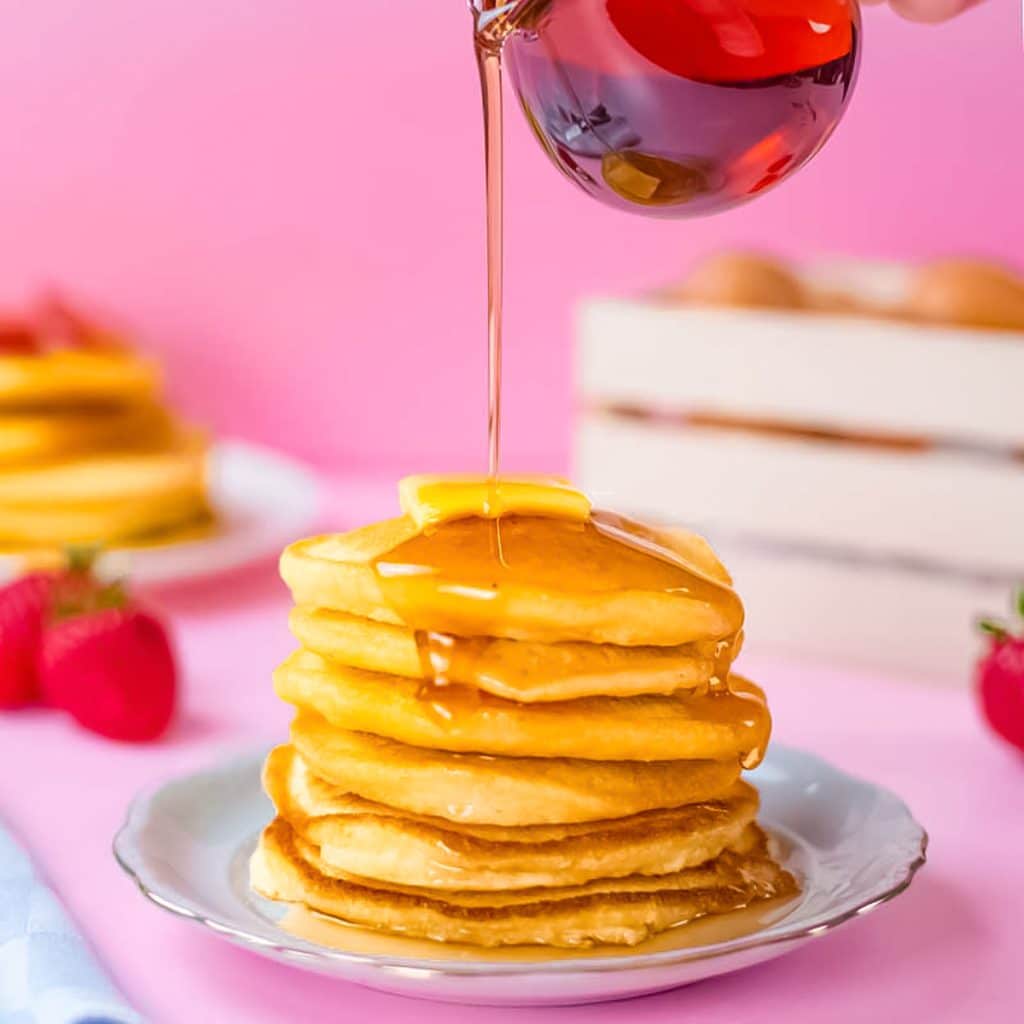 Keto pancakes stack with sugar free maple syrup on a plate.