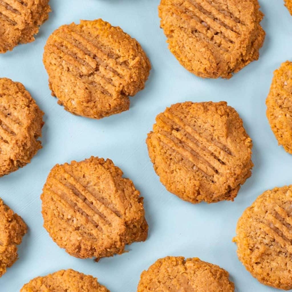 Keto peanut butter cookies on a blue background.