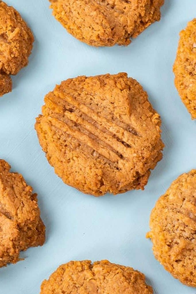 Keto peanut butter cookies on a blue background.