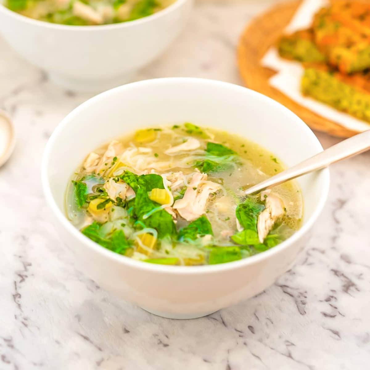 keto chicken soup in a white bowl.