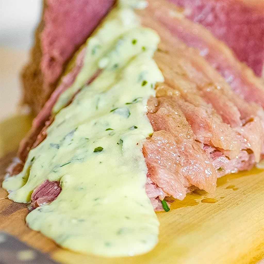 Corned beef with mustard sauces poured over it.