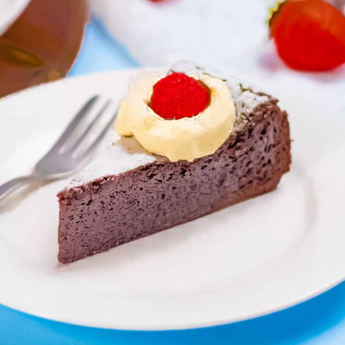 Ket flourless chocolate cake on a white plate.