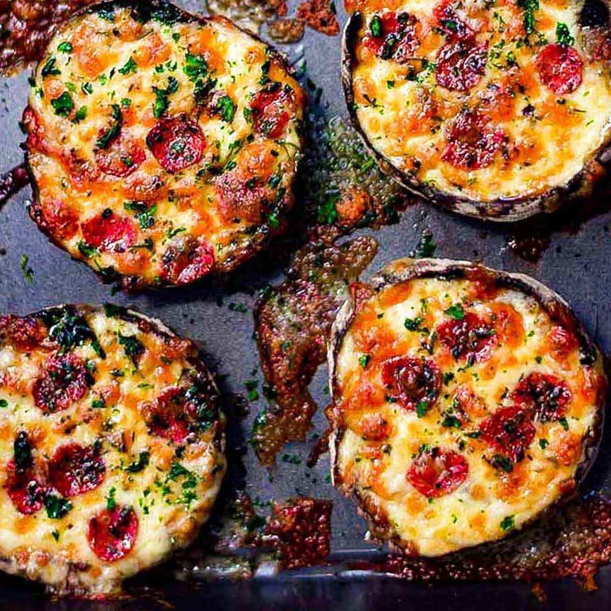 Keto pizza stuffed mushrooms on a baking tray.