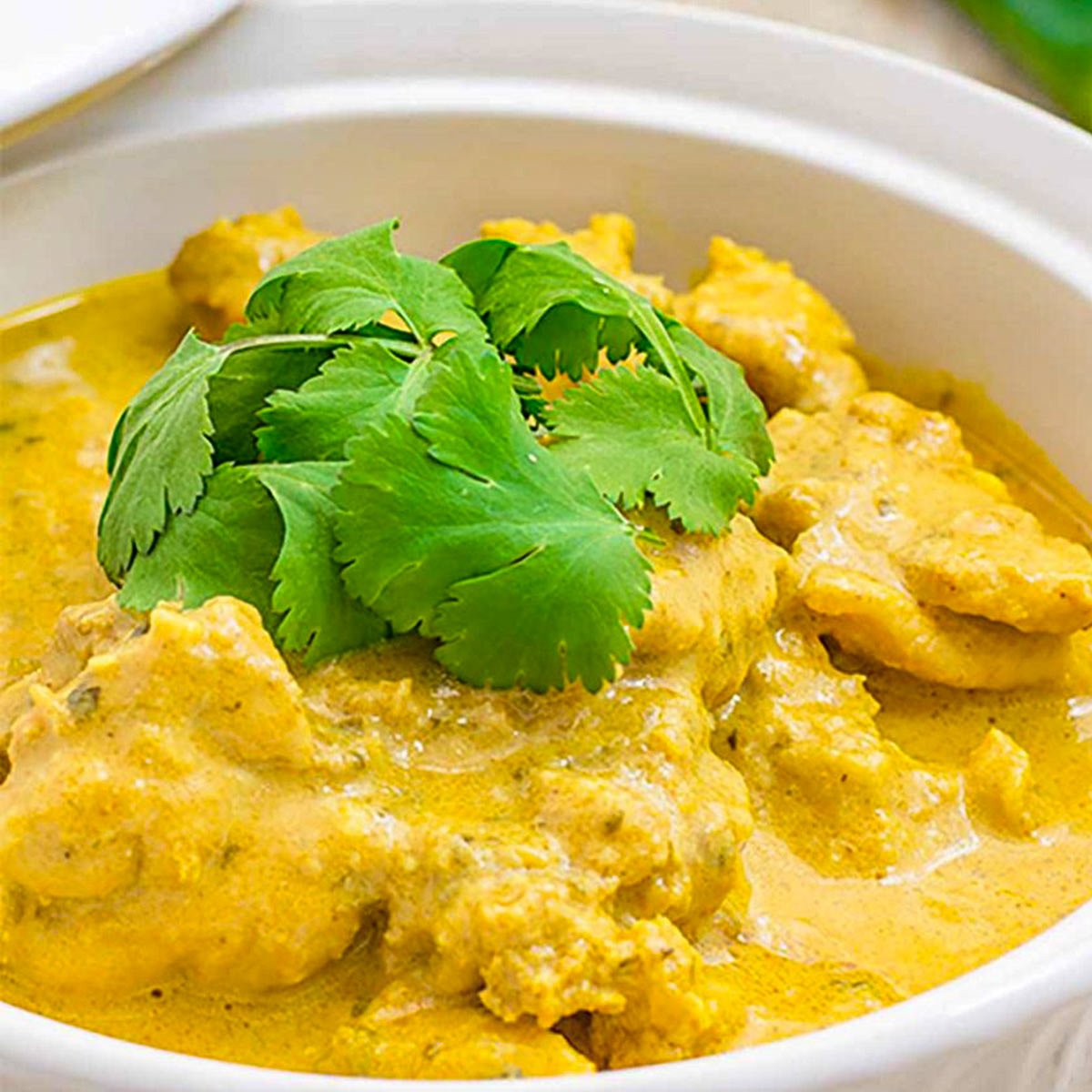 Keto chicken curry in a white bowl.