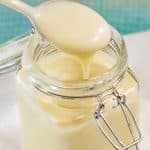 Spoon full of keto mayonnaise form a mason jar.