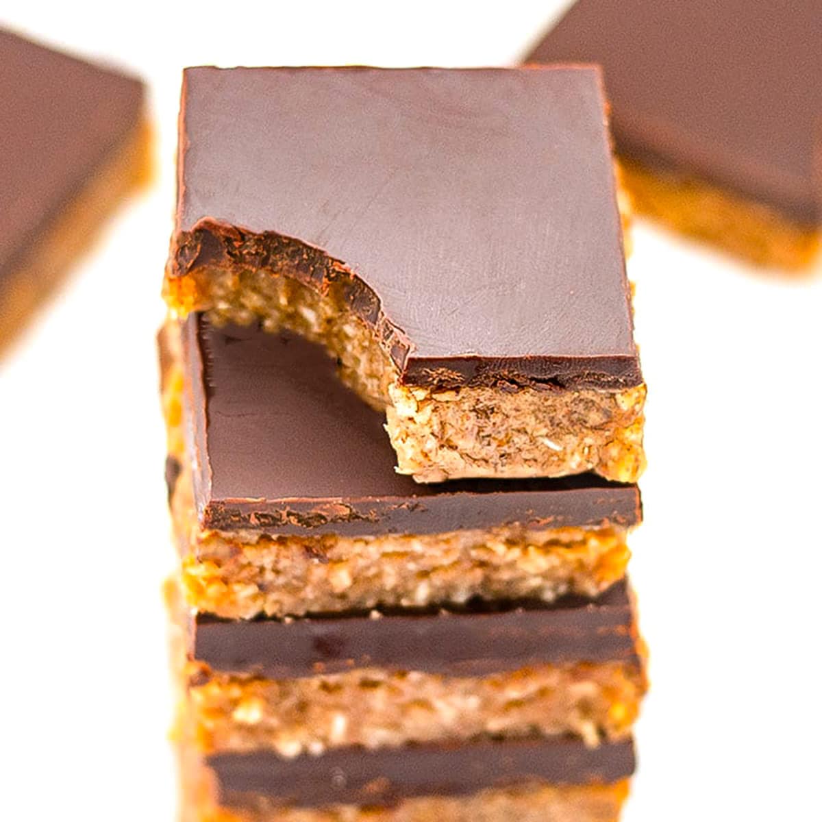Keto chocolate almond slice stack on top of each other.