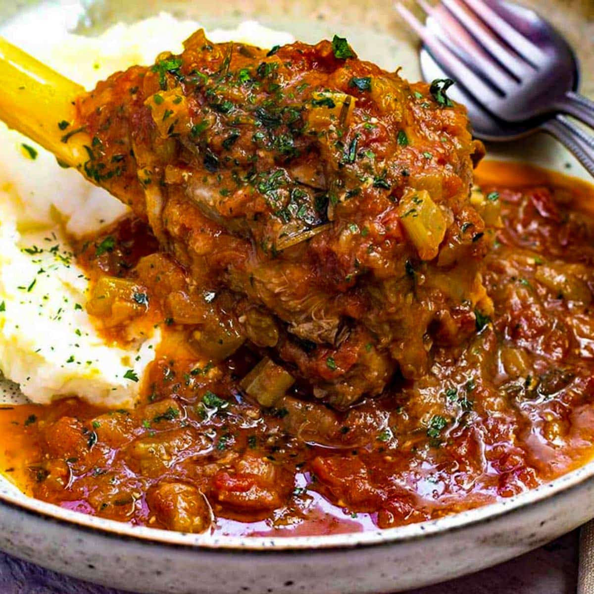 Keto lamb shanks in a bowl with cauliflower mash.