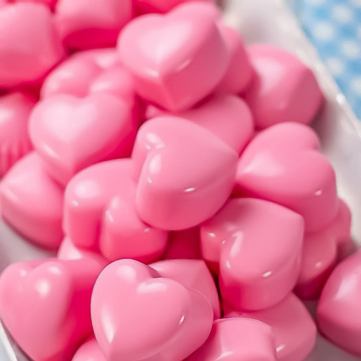 keto heart shaped fat bombs on a white plate.