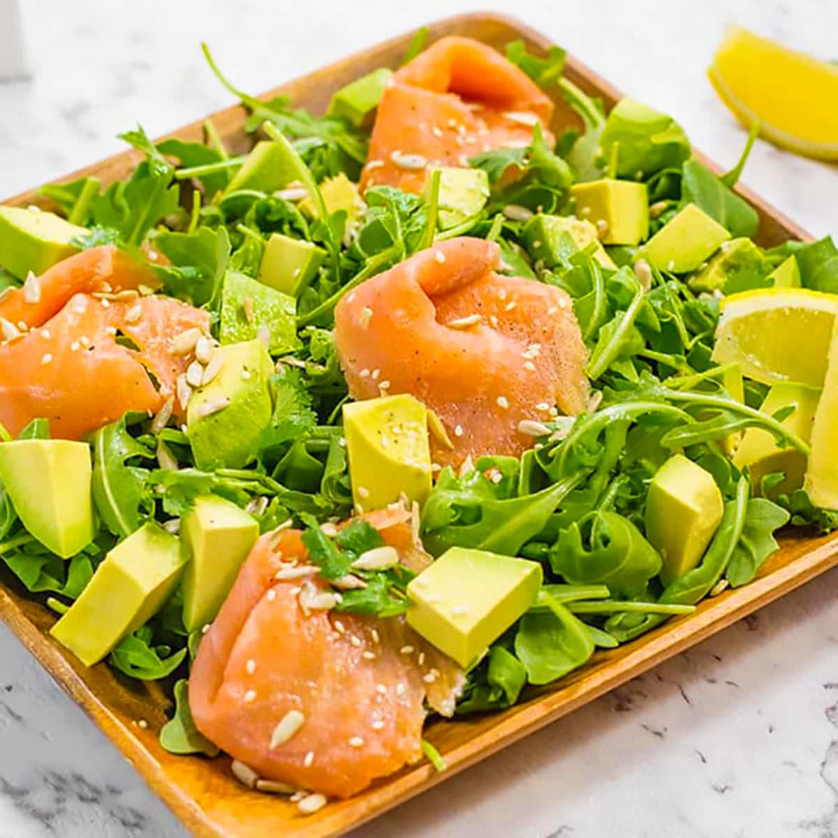 keto avocado and salmon salad in a brown salad bowl.