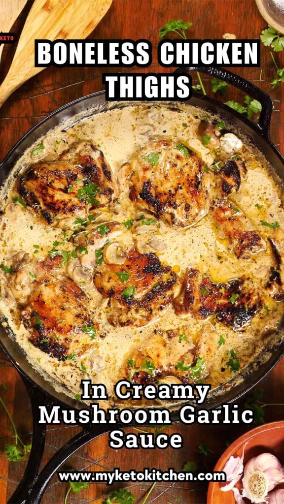 Skinless, boneless chicken thighs in a creamy garlic and mushroom sauce in a cast iron frying pan.
