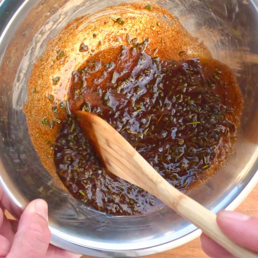 Keto chicken marinade being mixed in a silver bowl.