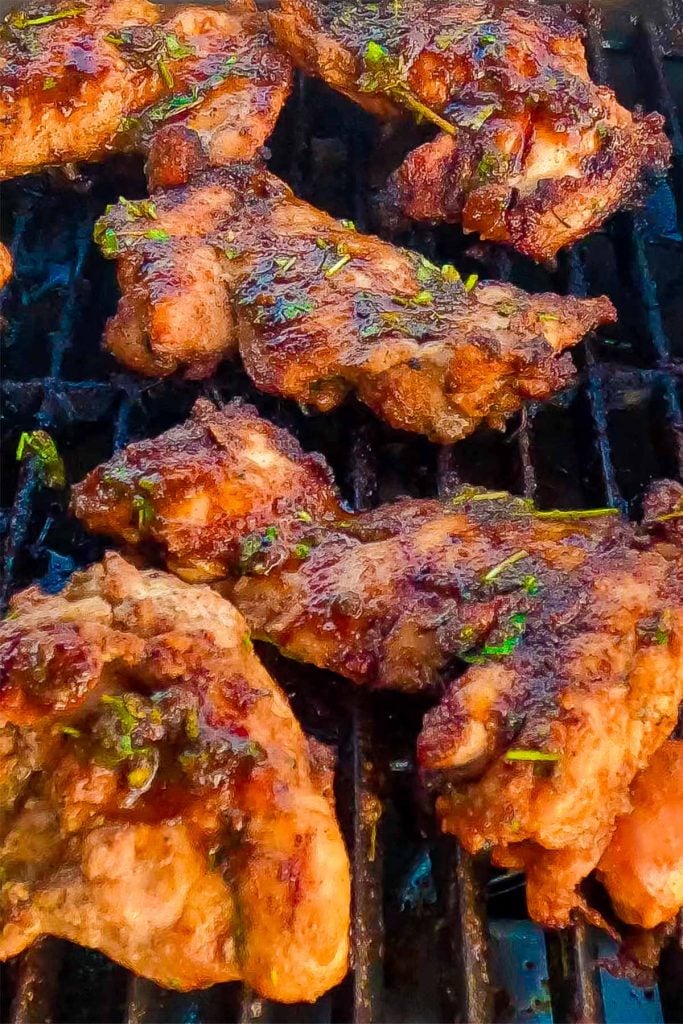 Keto boneless chicken thighs on a BBQ grill.